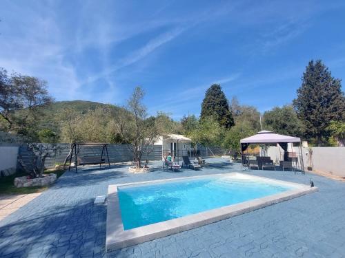 a swimming pool in a yard with a gazebo at Villa Gardiki for2 in Halikounas