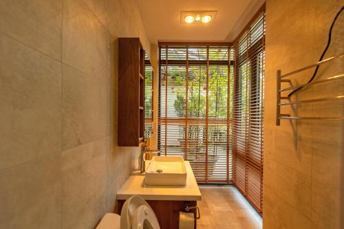 a bathroom with a sink and a window at Luxury 5 bedroom villa - Tuyen lam lake view in Xuan An