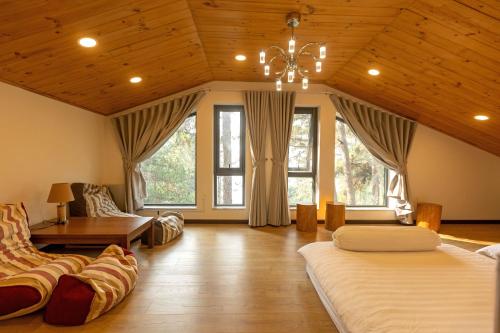 a large room with two beds and a chandelier at Luxury 5 bedroom villa - Tuyen lam lake view in Xuan An