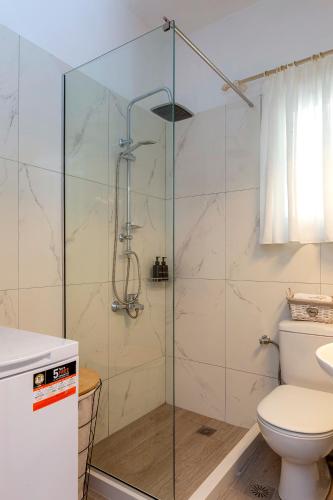 a bathroom with a glass shower with a toilet at Euphoria apartment in Corfu Town