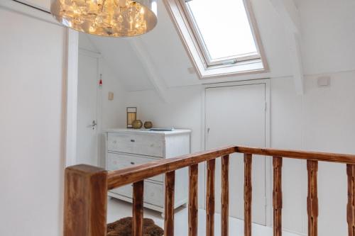 a room with a staircase and a skylight at B & B TX71 in Den Burg