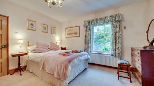 a bedroom with a bed and a window and a dresser at Wharf in Cromford