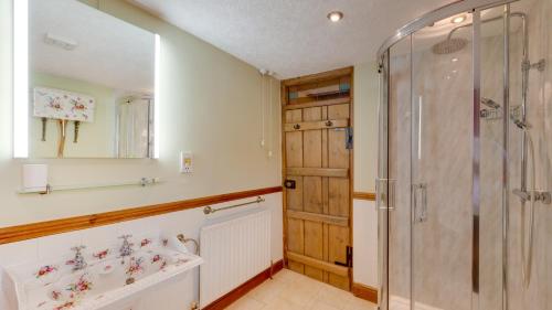 a bathroom with a shower and a sink at Wharf in Cromford