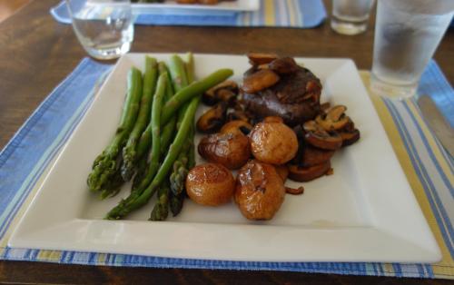 a plate of food with meat and vegetables on a table at Johnson Shore Inn in Harmony Junction