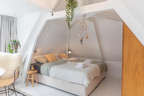 a bedroom with a bed in a attic at B & B TX71 in Den Burg