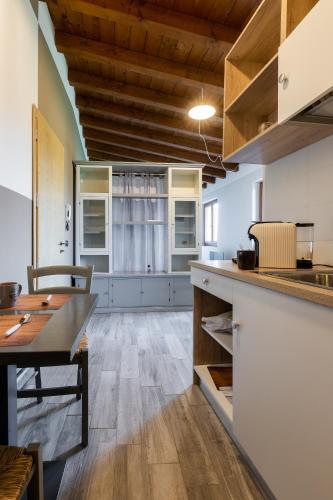 a kitchen with a table and a dining room at Angolo Nascosto Apartments in San Fiorano