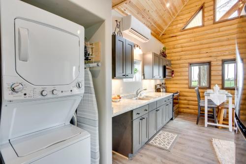 Il comprend une cuisine avec un réfrigérateur blanc et des murs en bois. dans l'établissement Secluded Grand Junction Getaway with Sweeping Views!, à Fruita