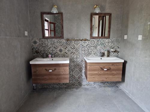 a bathroom with two sinks and two mirrors at Cyprus Village House in Kyrenia