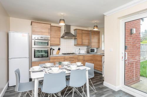 a kitchen and dining room with a table and chairs at Durham Heights in Leyland
