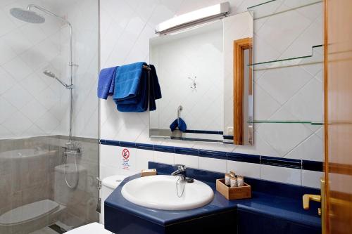 a bathroom with a sink and a toilet and a mirror at Callao Beach 6 in Arrieta
