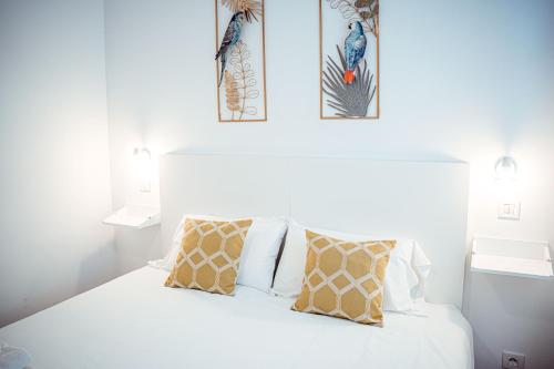 a white bed with two pillows on top of it at My City Home - Amplio apartamento en Salamanca in Madrid