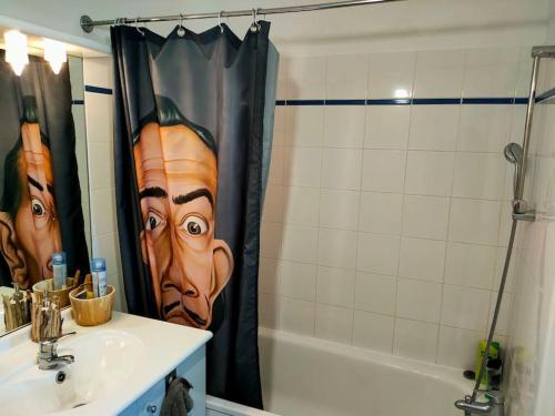 a bathroom with a shower curtain with a face on it at Au pied des calanques, nature, plages à 6min, parking, bus direct, idéal famille in Marseille
