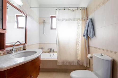 a bathroom with a sink and a toilet and a shower at Savvinas House Faliraki-Traganou Beach in Faliraki