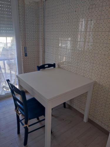 a white table and two chairs in a room at Residenza al Lago in Germignaga