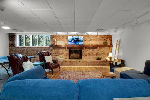a living room with a blue couch and a fireplace at Cozy Retreat near Paris Mtn State Park Sleeps 12 in Greenville