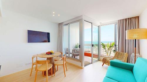 a living room with a table and a blue couch at Sea Nest in Portimão