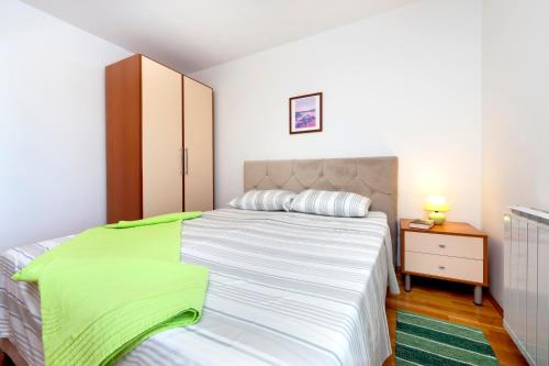a bedroom with a large bed and a dresser at Villa Mara in Rovinj