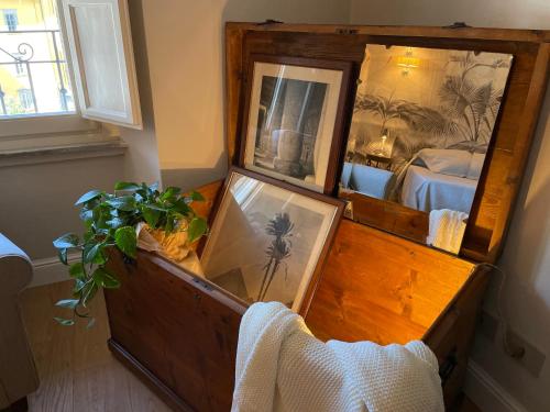 a wooden dresser with two mirrors and a bedroom at Burlamacchi Villas in Bagni di Lucca