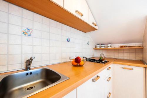 a kitchen with a sink and a bowl of fruit on the counter at Villa Mara in Rovinj