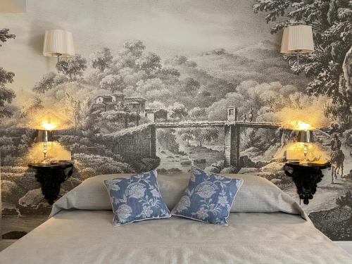 a bedroom with a wall mural of a bridge at Burlamacchi Villas in Bagni di Lucca