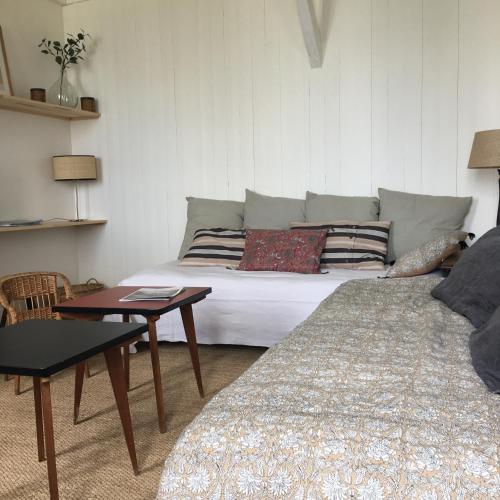 un salon avec deux lits et une table dans l'établissement QUAI 77•St Valery Centre •VUE DIRECTE BAIE - 6/12 pers, à Saint-Valery-sur-Somme