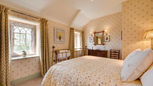 a bedroom with a bed and a window at Railway Cottage 