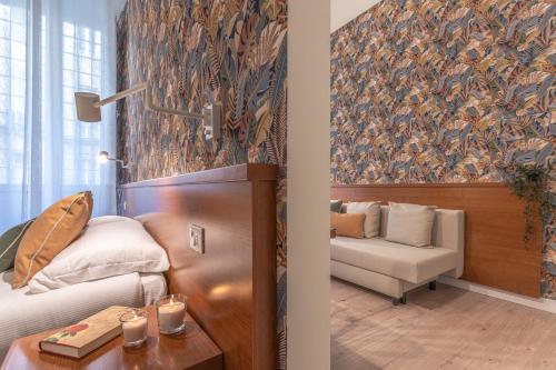 a room with a bed and a couch and a chair at Vittoria Garden Suites in Rome