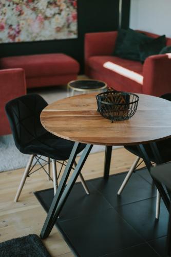 a table and two chairs in a living room at Halacs Homes- Boutique cabins, Boutique Cabin in Balatonalmádi