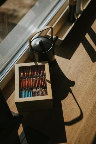 a tea pot sitting next to a box of matches at Halacs Homes- Boutique cabins, Boutique Cabin in Balatonalmádi