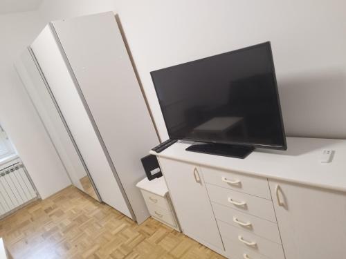 a living room with a tv on a white dresser at Apartma MB center in Maribor