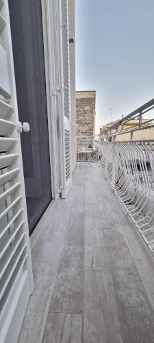 an empty walkway on a building with a fence at Il civico storico in Brindisi