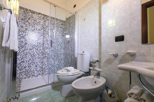 a bathroom with a toilet and a sink and a shower at Hotel Sant'Elia in Messina