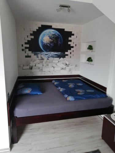 a bed in a room with a brick wall at Apartament Skawina in Skawina