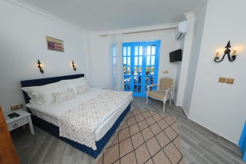 ein Schlafzimmer mit einem Bett und einer blauen Tür in der Unterkunft Bellapais Abbey Boutique Hotel in Kyrenia