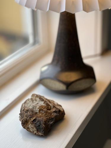 a rock sitting on a table next to a vase at Hotel Klostergaarden in Allinge