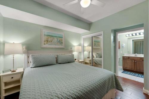 a bedroom with a bed and a bathroom at Seychelles 1007 in Panama City Beach