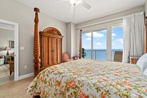 a bedroom with a bed with a view of the ocean at Treasure Island 0507 in Panama City Beach