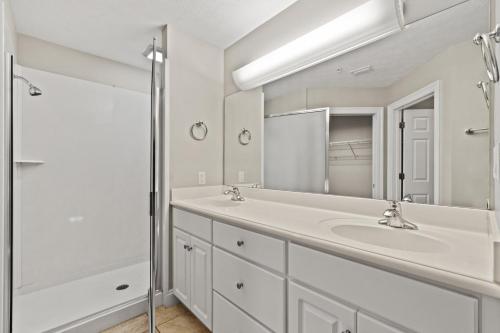a white bathroom with a sink and a shower at Treasure Island 0507 in Panama City Beach