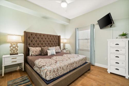 a bedroom with a large bed and a television at Treasure Island 0303 in Panama City Beach