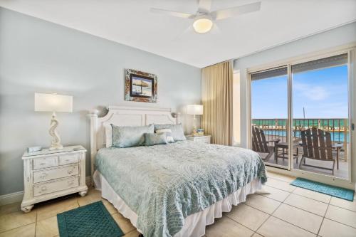 a bedroom with a bed and a view of the ocean at Treasure Island 0110 in Panama City Beach