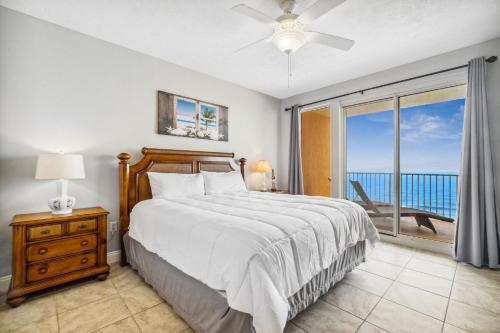 a bedroom with a bed and a view of the ocean at Treasure Island 1808 in Panama City Beach