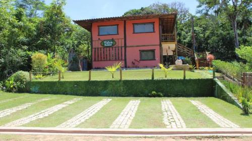a house with a garden in front of it at Chalés Yababali in Ubatuba