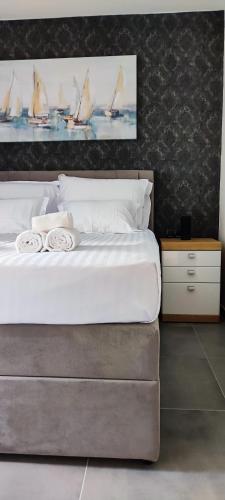 a bedroom with a large white bed with sails on the wall at Apartment Denis in Krk