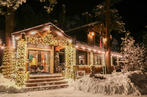 a house covered in christmas lights in the snow at Castle Mountain Lodge in Estes Park