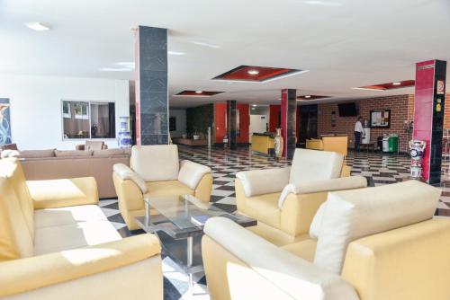 a waiting room with couches and chairs at Hotel Beijing Caucasia in Caucasia