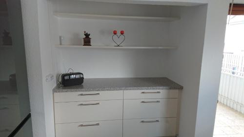 a kitchen with white cabinets and a counter top at Apartment Ferienwohnung Vogt in Sinzheim