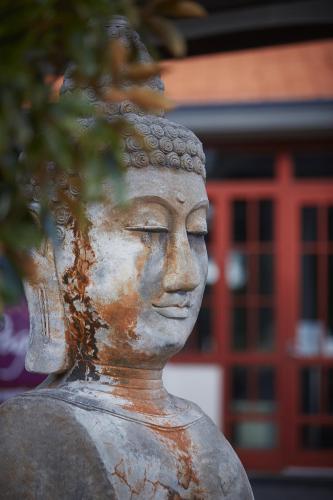 a statue of aitating woman in front of a building at Pagoda Resort & Spa in Perth