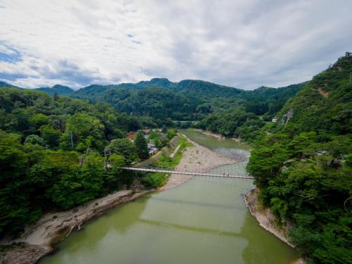 an aerial view of a bridge over a river at Takanosukan in Sekikawa