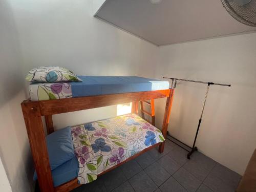 a small bedroom with two bunk beds and a lamp at Buganvilla No 3 in Quepos