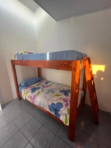 a bunk bed in a room with a flowery mattress at Buganvilla No 3 in Quepos